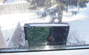 Hard-drive covered in snow outside on window-sill