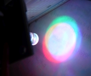 RGB LED casting its colors on a white paper which looks like three overlapping circles
