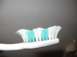 Worn toothbrush from the side.